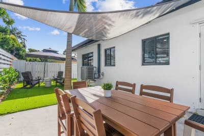 Dine al fresco on the rear patio, complete with a table and seating—perfect for enjoying meals outdoors in a peaceful setting.