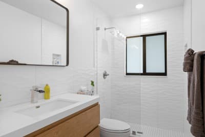 Freshen up in the sleek, modern bathroom featuring a frameless glass shower, stylish finishes, and all the essentials.